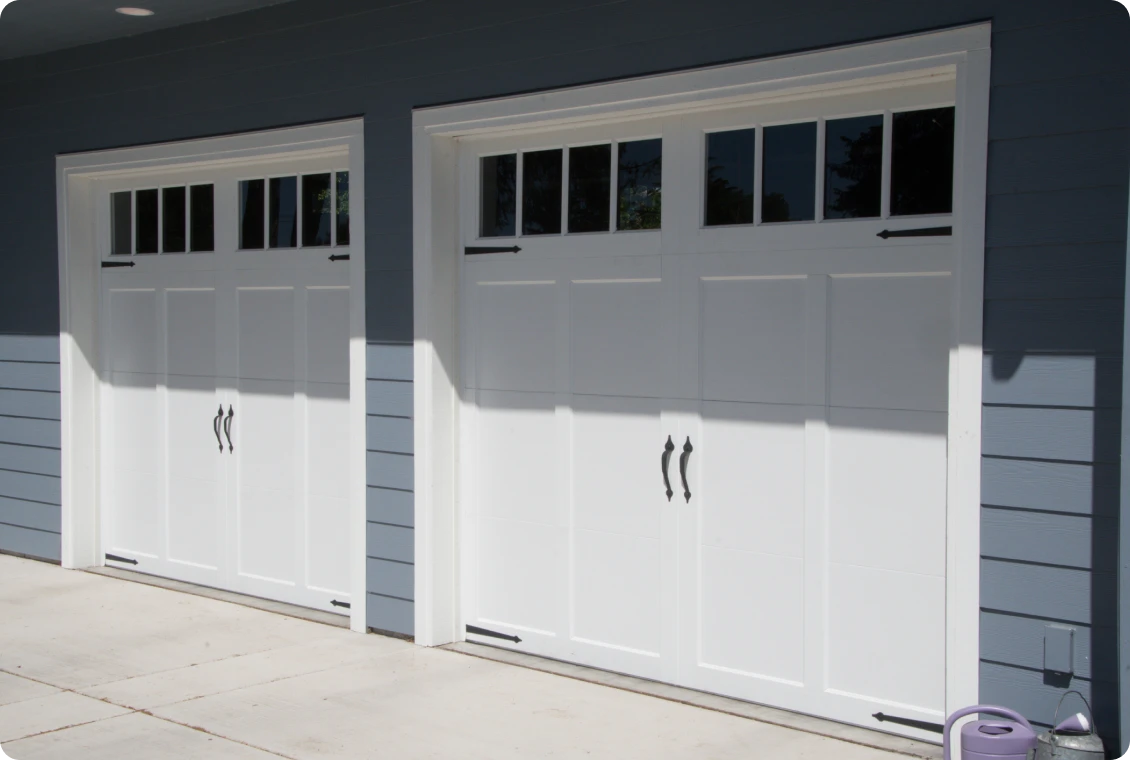 Modern garage doors on blue house