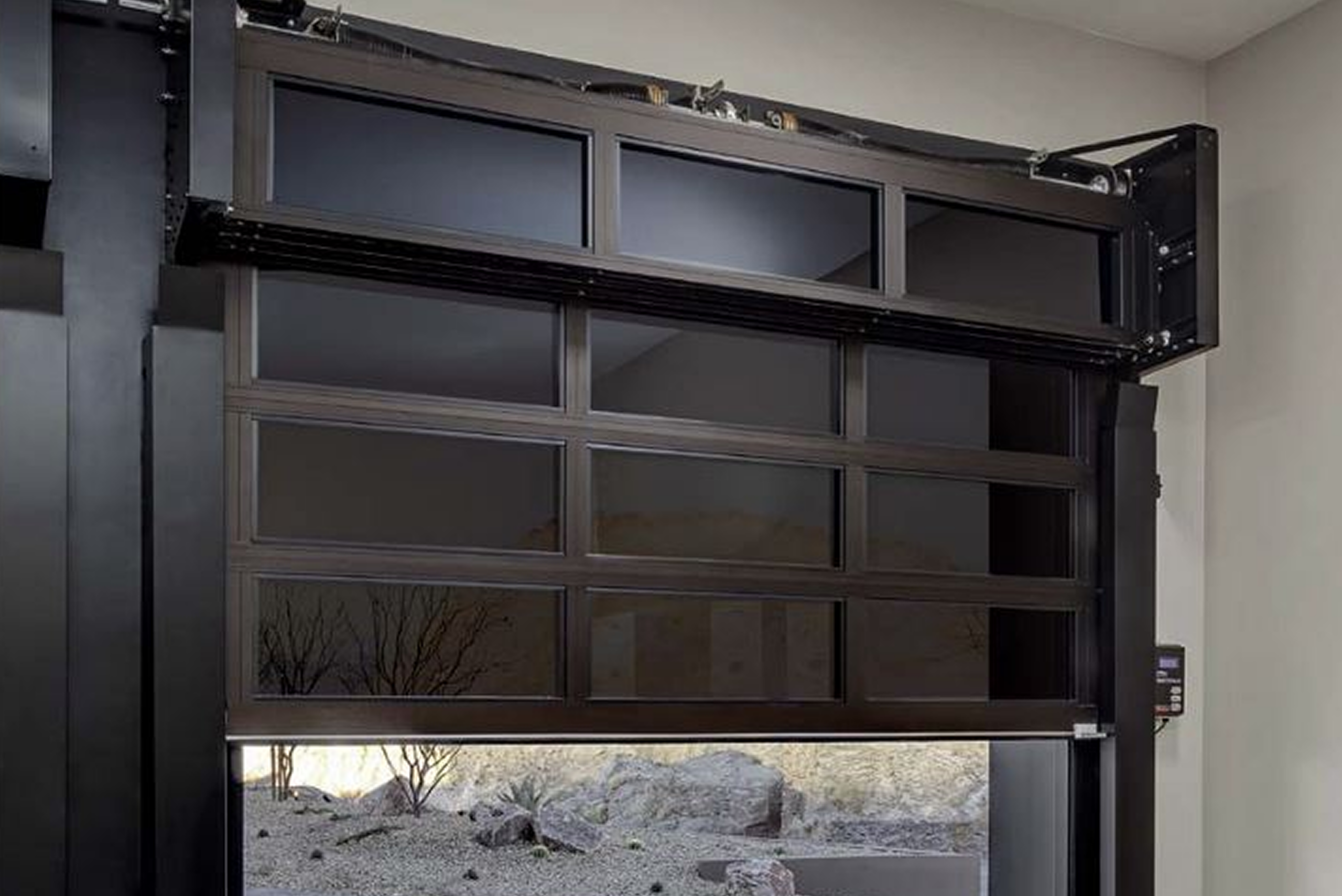 Glass-panel garage door partially opened indoors.