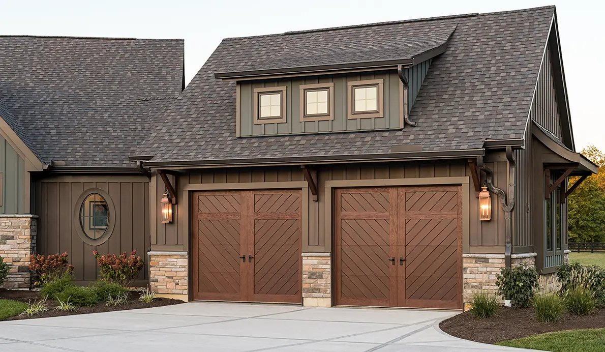House with double wooden garage doors.
