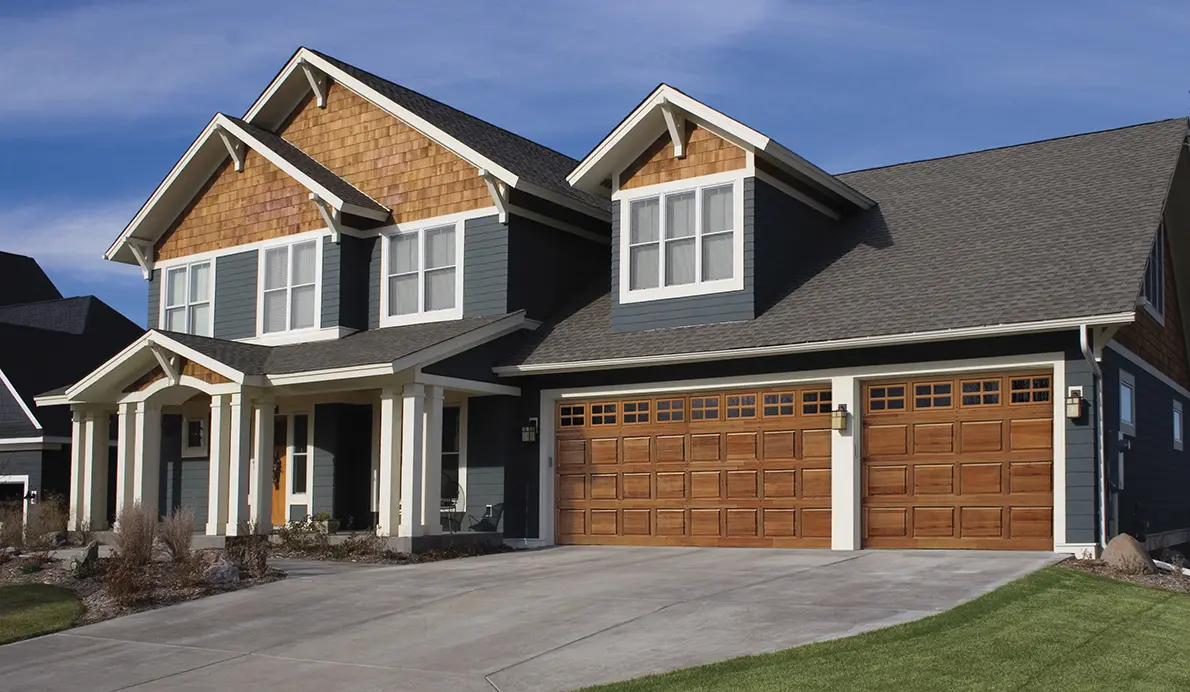 Modern two-story house with wooden garage.