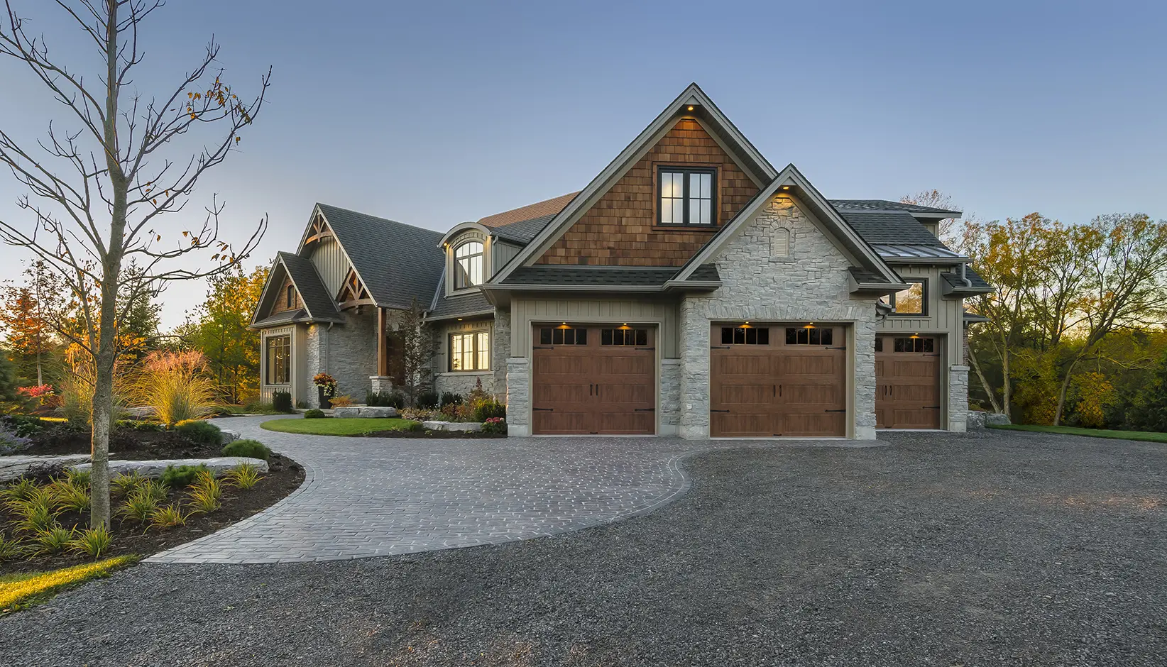 Modern house with three-car garage driveway.