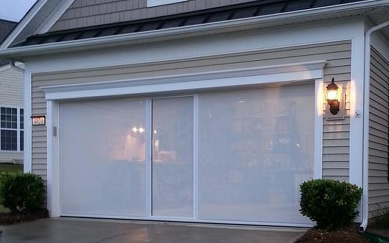 Garage with closed sliding screen door.