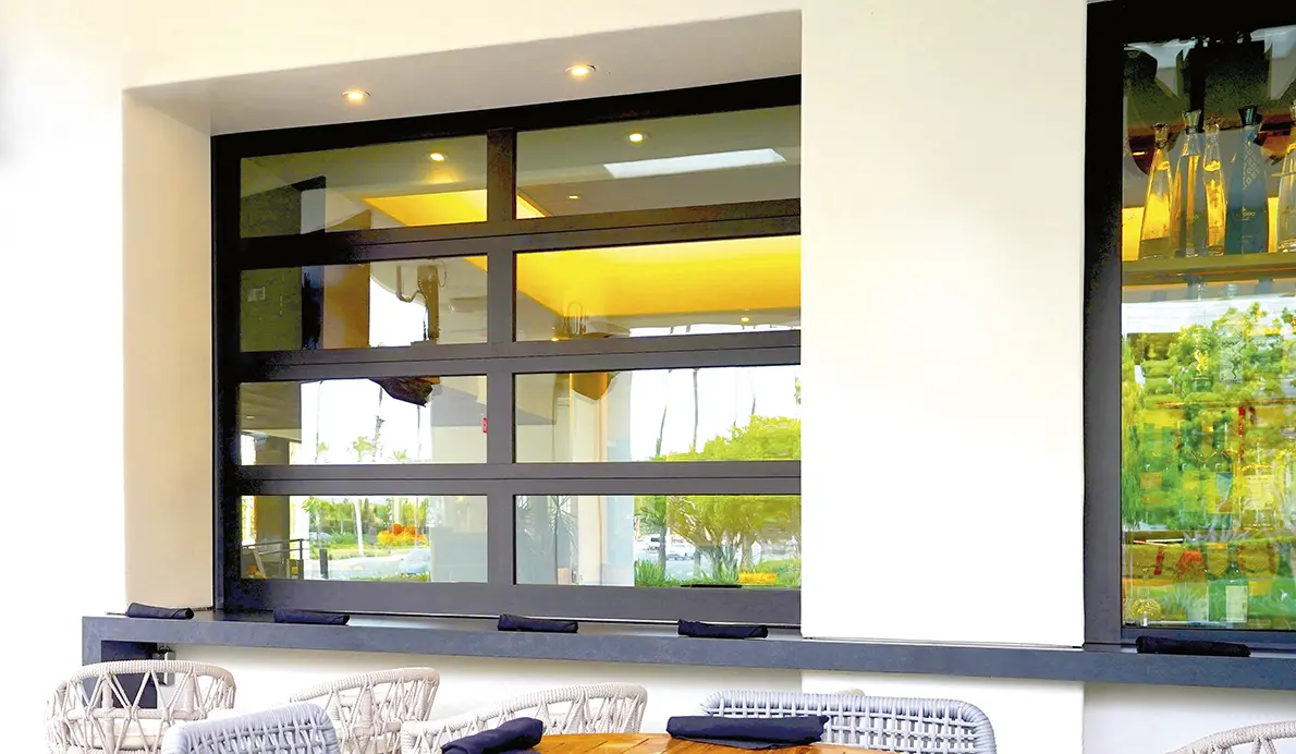 Outdoor seating area with modern glass window.